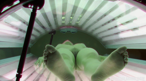 Toned brunette showing her naked body in a tanning bed